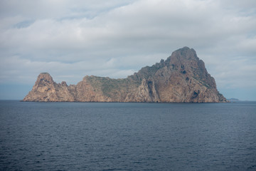 The island of es vedra from behind from a boat