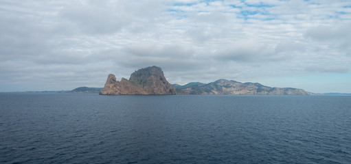 The island of es vedra from behind from a boat