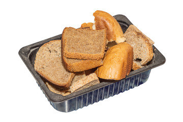 Pieces of old dried bread in a plastic container isolated on white background