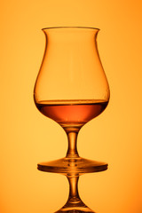 Glas Whisky orange im Gegenlicht