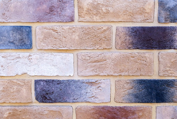 Brick wall with variegated brown bricks. Used as a background.