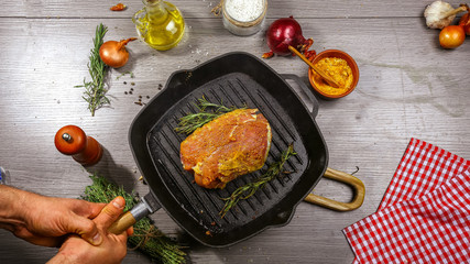 Grilled steak with spices on grill iron pan. Food background. copy text menu