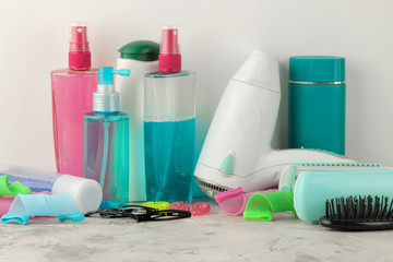 Various hair care products and various hair accessories for combs, elastics, hair curlers, hair dryers. on a light background. hair cosmetics.