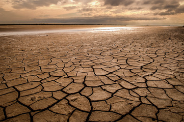 Dry and cracked earth at sunset in Camargue, France