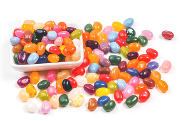 Fototapeta na wymiar Jelly bean sweets in a rectangular bowls on white background isolated, side view with copy space