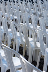 Composition with white chairs in outdoor auditorium