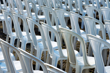 Composition with white chairs in outdoor auditorium