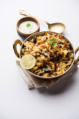 Keema or Kheema Biryani - Fragrant and spicy minced lamb or goat or chicken cooked in range of aromatic spices with basmati rice. served in a karahi with curd. selective focus