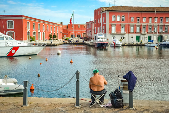 Man Fishing At The Port Of Naples, Italy