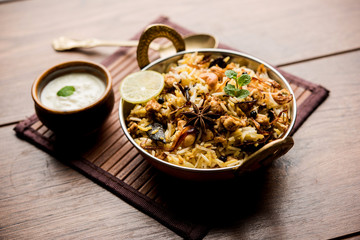 Keema or Kheema Biryani - Fragrant and spicy minced lamb or goat or chicken cooked in range of aromatic spices with basmati rice. served in a karahi with curd. selective focus