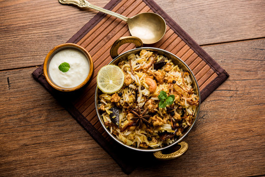 Keema or Kheema Biryani - Fragrant and spicy minced lamb or goat or chicken cooked in range of aromatic spices with basmati rice. served in a karahi with curd. selective focus