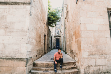 Obraz na płótnie Canvas .Young man doing sightseeing around the beautiful city of Bordeaux in France. Feeling free and happy discovering new places. Travel photography.