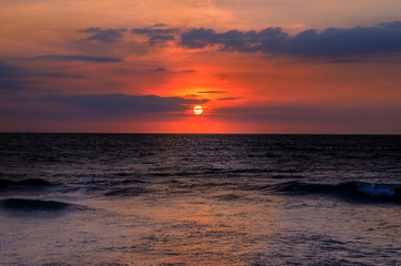 Beach of the ocean and red sunset.