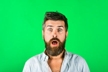 Surprised bearded man with long beard&mustache. Astonished man in casual clothes. Amazed fashionable bearded male. Fashion model with stylish hair. Hipster in white shirt. Barber fashion and beauty.