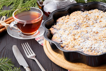 Traditional Homemade chocolate Christmas cake sprinkled with sugar powder, new year tree decoration with snow