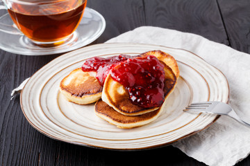 Homemade pancakes with berry sauce coulis