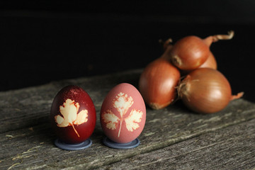 Obraz na płótnie Canvas Easter Eggs Decorated with Natural Grass and Boiled in Onions Peels, Rural Style.painting eggs with natural dyes.