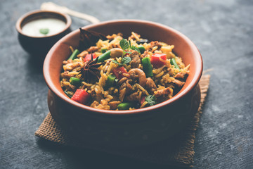 Kheema Pulao - Rice cooked with mutton or chicken mince with vegetables and spices. served in a bowl. selective focus