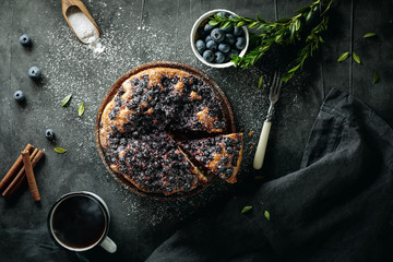 Flat lay with sliced homemade blueberry pie on dark background  - obrazy, fototapety, plakaty
