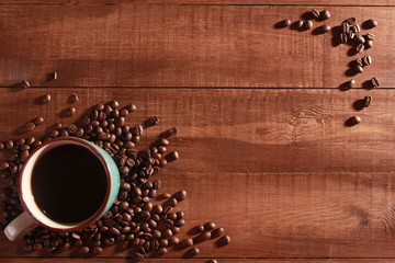 Coffee and beans on vintage wooden table. Coffee break concept. Blue cup, winter drink, espresso, top view