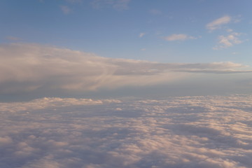 Fototapeta na wymiar Sky with clouds at sunset from inside the plane landscape