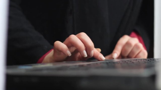 Women's hands work with a laptop