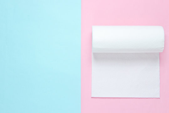 Roll Of Paper Towels On Blue Pink Pastel Background. Minimalism. Top View. Copy Space. .