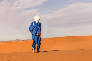 Berber walking on Sand Dune in Erg Chebbi desert