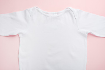 Layout Flat Lay white baby shirt, on a pink background, for the girl.Mock up for design and placement of logos, advertisements