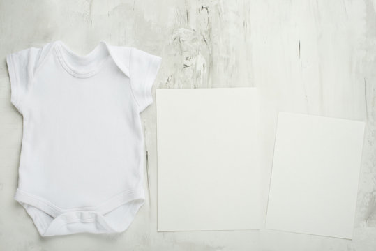 Layout Flat Put on a two white baby body shirt, on a white background. Layout for design and placement of logos, advertising