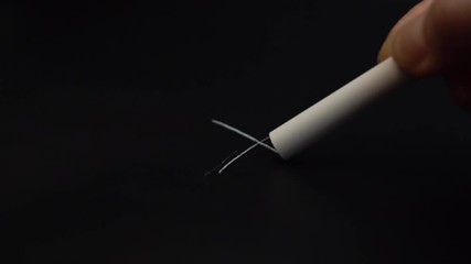 Drawing in white chalk on the fabric of the tailor