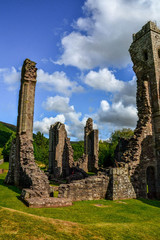 Landmarks of Wales travel concept. View of ancient ruins of the castle/church in Brecon Beacons National Park, United Kingdom. Popular tourist attraction (Llanthony Priory,Hay-on-Wye, Black Mountains)