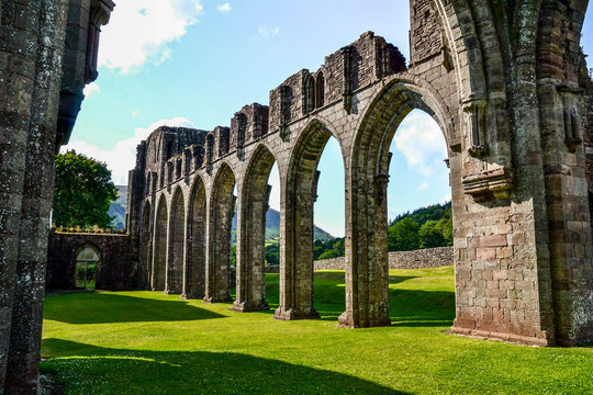 Landmarks of Wales travel concept. View of ancient ruins of the castle/church in Brecon Beacons National Park, United Kingdom. Popular tourist attraction (Llanthony Priory,Hay-on-Wye, Black Mountains)