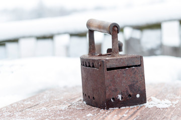 Ancient iron iron for ironing coals. Iron. on wooden background