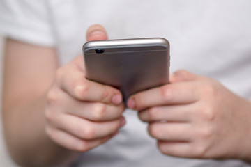 baby hands hold smart phone on blurred background. For graphic displey montage.