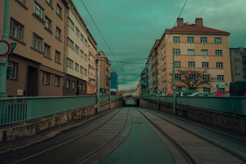 Fototapeta na wymiar Dark urban scene with a view of tram rails.