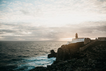 View of the lighthouse and cliffs at Cape St. Vincent in Portugal at sunset. The most south-western...