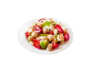 Salad with three kinds of tomatoes, boiled white kidney beans and croutons from white bread isolated on white backgroung with clipping path