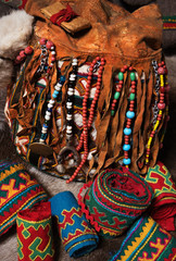 Elements of traditional winter cloth and rich decorated fabrics and hand made leather handbag of nomadic tribe of Far North, Polar Circle of Russia