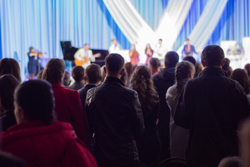 A crowd of people at a concert in the hall.
