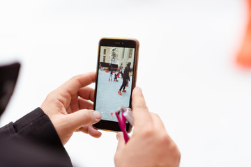 Ice skaters photographed by the camera of a mobile phone
