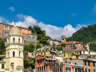 Fototapeta na wymiar Vernazza summer view with the bell tower of the Church of Santa Margherita d'Antiochia in the foreground, Cinque Terre, Italy