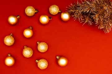 Creative horisontal pattern with golden Christmas tree branches and multiple golden baubles. Concept