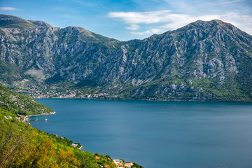 Panorama of lake with big mountains, adreatic in Montenegro in calm waters of sea