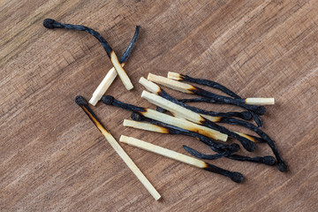 Burned wooden matches sticks on a wooden table background