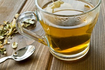 Cup with green tea on wooden background