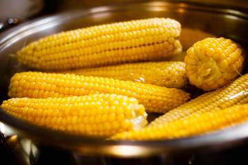 Boiled corn in hot water
