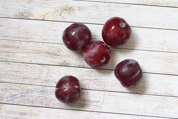plums on wooden table