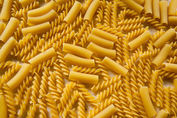 Uncooked pasta Rigatoni and Fusilli on wooden background. Cooking concept. Top view - Image