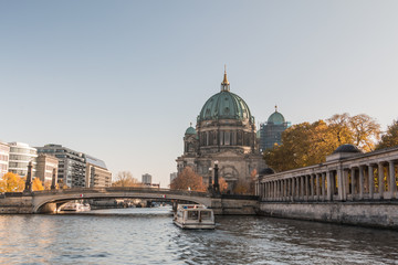 Berlin Cathedral with the Frederick's Bridge at blue sky. Arcade of the National Gallery on the...